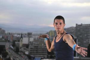 young man jumping in air outdoor at night ready for party photo