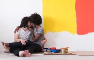 young multiethnic couple relaxing after painting photo