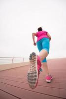 woman busy running on the promenade photo