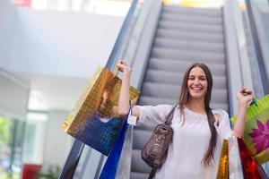 Happy young woman in a shopping mall photo