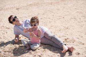 Mom and daughter on the beach photo