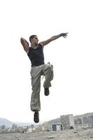 young man jumping in air outdoor at night ready for party photo