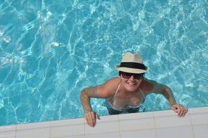 Happy woman in swimming pool photo