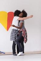 couple with painted heart on wall photo