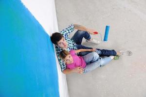 happy young cople relaxing after painting in new home photo