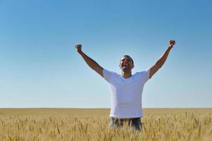 man in wheat field photo