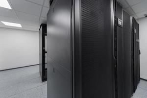 Data Center With Multiple Rows of Fully Operational Server Racks. Modern Telecommunications, Cloud Computing, Artificial Intelligence, Database, Supercomputer Technology Concept. photo