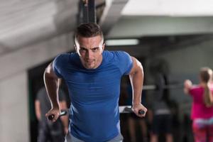 man doing exercises parallel bars photo