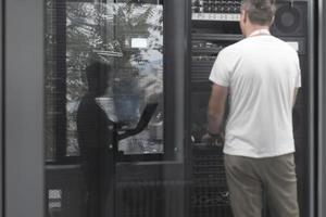 Technicians team updating hardware inspecting system performance in super computer server room or cryptocurrency mining farm. photo