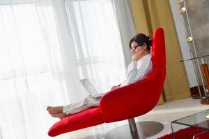 woman using a laptop computer at home photo