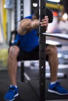 man doing pull ups on the vertical bar photo