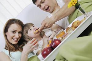 happy young family eat breakfast in bed photo