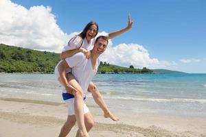 happy couple have fun on the beach photo