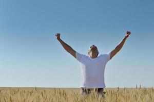 man in wheat field photo