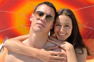 happy young couple have fun on beach photo