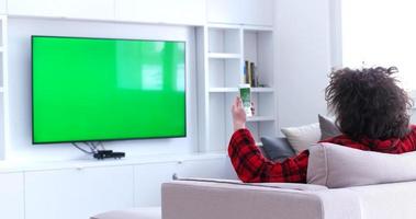 Young couple on the sofa watching television photo