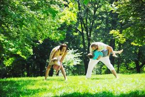 happy young couple with their children have fun at park photo