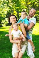 happy young couple with their children have fun at park photo