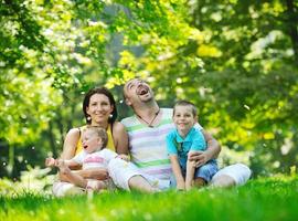 happy young couple with their children have fun at park photo