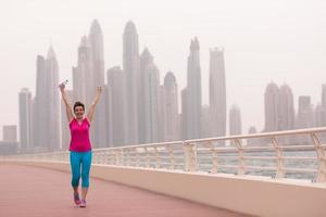 young woman celebrating a successful training run photo