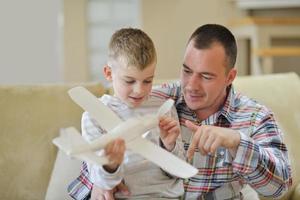 father and son assembling airplane toy photo