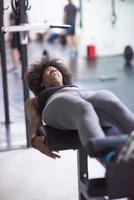 black woman doing sit ups at the gym photo