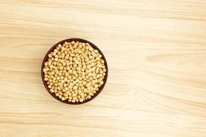 soybean in a bowl on wooden background, top view, flat lay, top-down, selective focus.copy space. photo