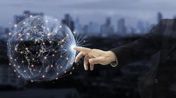 Hologram globes and networked connections in the hands of businessmen. communication network concept. photo