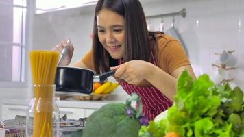 Young Asian woman cooking in kitchen at home. photo