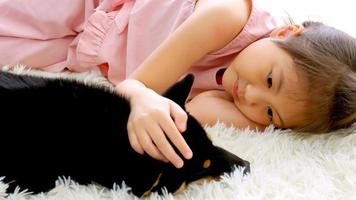 Asian little girl sleeping with her dog at home. photo