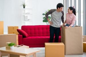 Happy young couple moving to new house together. photo