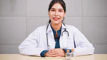 Asian woman doctor talking with patient via video call conference. photo