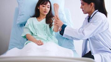 Female doctor checking up patient's body after recuperating from surgery. photo