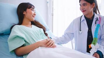 A female doctor explains the physical characteristics of the patient before the operation. photo