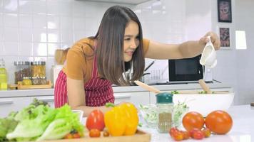 Young Asian woman cooking in kitchen at home. photo