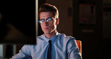 man working on computer in dark office photo