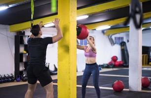 young athletes couple working out with medical ball photo