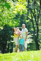 happy young couple with their children have fun at park photo