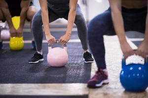 athletes doing exercises with kettlebells photo