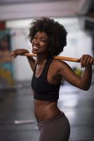 black woman lifting empty bar photo