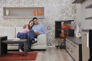 couple relax at home on sofa in living room photo