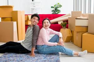 Happy young couple moving to new house together. photo