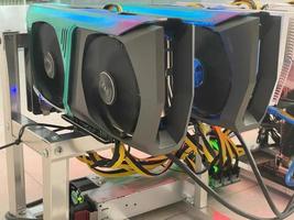 Row of bitcoin miners set up on the wired shelfs. Device for mining crypto currency. Mining cryptocurrency. Bitcoin farm. Machines for mining cryptocurrency bitcoin. Electronic device at day. photo