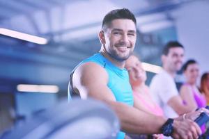 Group of people running on treadmills photo