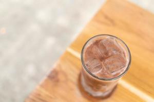 Chocolate milk with iced in glass on wooden table. Iced chocolate latte photo