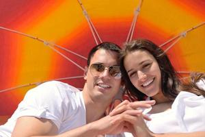 happy young couple have fun on beach photo