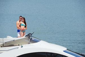 young couple on yacht photo