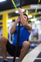 man doing rope climbing photo