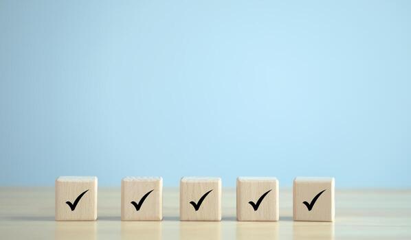 Checklist, Task list, Survey and assessment. Quality Control, confirm, accept, validation, Goals achievement and business success. Check mark icon on wooden blocks. photo