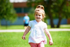 little girl have fun in park photo